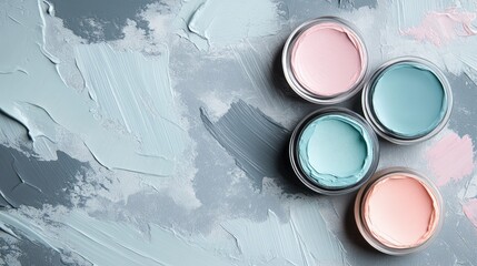 Poster - Four jars of pastel-colored paint arranged on a textured gray background with paint strokes and Copy Space for text insertion