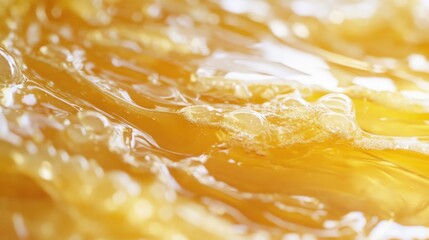 Poster - Abstract close-up of golden liquid with bubbles and fluid surface, showcasing texture and movement, suitable for backgrounds with copy space.