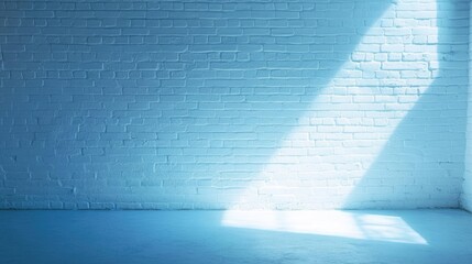 Poster - Blue painted brick wall with sunlight streaming in creating a geometric shadow on the ground Copy Space