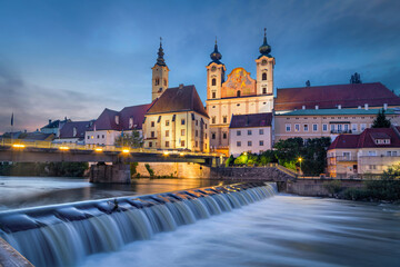 Wall Mural - Steyr, Austria. Saint Michael church and bridge over Steyr river at dusk