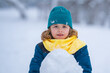 © Volodymyr - Kid looking at snow man in winter. Snowman with a carrot nose on a winters day. Child making snowman. Little boy building snowman in snowy park. Child embracing snowman in a snowy winter park.