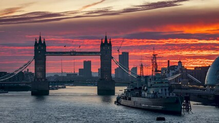 Wall Mural - Beautiful sunrise time lapse view of the iconic Tower Bridge in London, England, with red and golden clouds