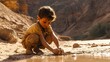 © cynz - A child digging in the sand of an arid riverbed, their curiosity evident as they discover small treasures