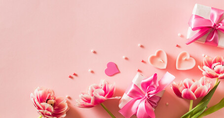 Wall Mural - Pink tulips and hearts, gift box with ribbon on light pink background