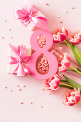 Wall Mural - Number eight with bouquet of tulips on a pink background. International Women's Day concept