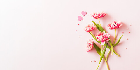 Wall Mural - Pink tulips and hearts on a light pink background