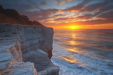 Wall Mural - a serene sunset scene on a beach with calm waves and clear sky