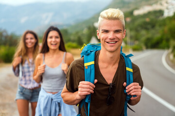 Wall Mural - friendship, travel, vacation, summer and people concept. group of smiling friends with map traveling