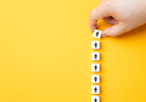 Hand making a row of arrows on a yellow background. Space for text. Paving the way, making plans. Next steps and vision. Course to go forward.