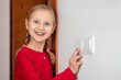 © Maryana - Turning off Light Switch.  Little Girl Child Turns off the Light, Learning Good Habits. Conserve Energy concept.