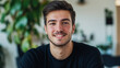 © InspirationDesign - Young man with friendly smile in casual setting. Suitable for modern lifestyle, natural portraits, or approachable professionalism.