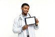 © Alisa - Portrait of young male doctor presenting tablet with blank screen and copy space for app ads, isolated on blue background