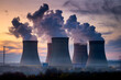 © Lubos Chlubny - Nuclear power plant cooling towers emitting smoke at sunset