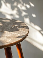 Canvas Print - Marble-Top Table in Sunlight - Modern minimalist style, featuring sunlight, shadows, marble texture, and wooden legs. Sleek and clean aesthetic.