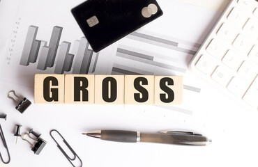 Aufkleber - Wooden blocks with the word Gross on a desk with financial charts