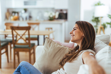 Wall Mural - Relaxed Woman Enjoying Comfort On Couch At Home In Bright Daylight