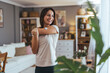 © Dragana Gordic - Happy Woman Checking Fitness Tracker in Cozy Living Room Setting
