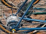 Detailed view of bicycle components highlighting gears and wheels in a close-up shot indoors