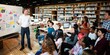 © Rawpixel.com - A diverse group of people in a library setting, listening to a presentation. The audience is engaged, with a mix of genders and ethnicities, focused on the speaker. Teacher teaching high school class.