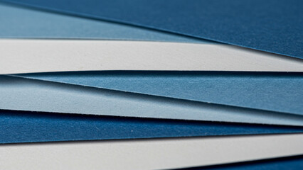 Poster - A close-up examination of blue and white paper in a layered formation, serving as a visual backdrop