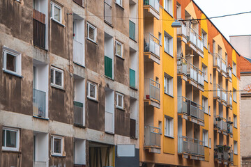 Wall Mural - architecturally interesting apartment blocks in the city center on the street. old construction of blocks of flats made of large panels. contrast of the building after renovation with the building bef