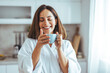 © Dragana Gordic - Woman Enjoying Morning Coffee in Cozy Home Kitchen Setting