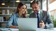 © scorpius design - Modern Office Collaboration: Professionals Working on a Laptop