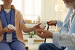 © New Africa - Caregiver giving pills to senior man indoors, closeup. Home health care service