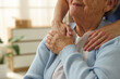 © New Africa - Caregiver supporting senior woman indoors, closeup. Home health care service