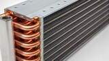 A closeup image of a crosssection of a cooling coil showcasing the intricate fins and fluid channels designed for optimal heat exchange.