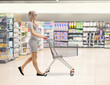 © Ljupco Smokovski - Woman at a supermarket pushing a shopping cart