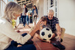 © Marko Geber - Grandparents and grandson playing with soccer ball on the porch