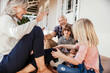 © Marko Geber - Grandparents and grandchildren playing with soccer ball on the porch