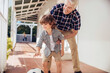 © Marko Geber - Grandfather and grandson playing with soccer ball on the porch