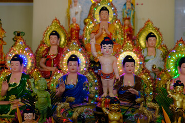 Wall Mural - Phuoc Long Buddhist pagoda.  Infant Buddha statue pointing the north. On Vesak Day, Buddhists  commemorates: the birth, enlightenment and the death of Buddha Gautama. Tan Chau. Vietnam.