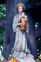 Wall Mural - Basilica of Our Lady of La Vang. Our Lady of La Vang holding a figure of the baby Jesus. Virgin Mary.  Vietnam.