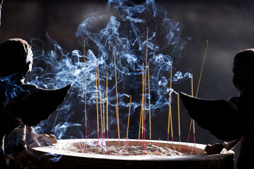 Sticker - Tac Say Church, also known as Father Diep Church.  Believer praying after lighting incense. Bac Lieu. Vietnam. .