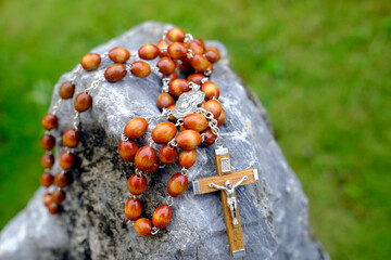 Wall Mural - Rosary on a rock. Symbol of strength and eternity. Catholic church. .