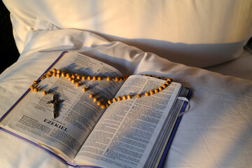 Wall Mural - Pray at home. Bible and Rosary on a bed.