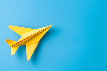 Yellow paper plane on blue background