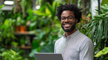 Wall Mural - A young professional in business casual, holding a laptop