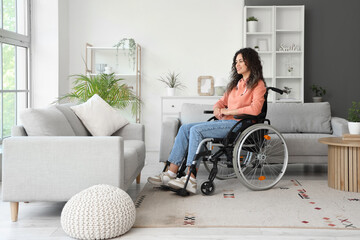 Wall Mural - Young African-American woman in wheelchair at home