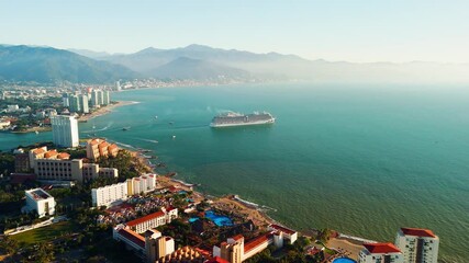 Wall Mural - Cruise ship sailing near Puerto Vallarta at sunset. Jalisco, Mexico