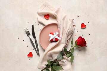 Wall Mural - Beautiful table setting with red rose, gift box and burning candles on white background. Valentine's Day celebration