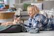 © Pixel-Shot - Beautiful middle-aged woman lying near cute cat in pet bed at home