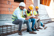 © Dragana Gordic - Construction Workers Relaxing and Socializing During a Job Site Break