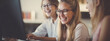 © Ardezart - Happy Students in Glasses at a Computer