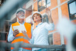© Dragana Gordic - Construction Engineers Analyzing Site Progress with Digital Tablet at Job Location