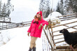 © Marharyta - Woman next to the sheep pen in countryside in the snow in winter in the mountains. Cozy hygge travel holidays retreat destination