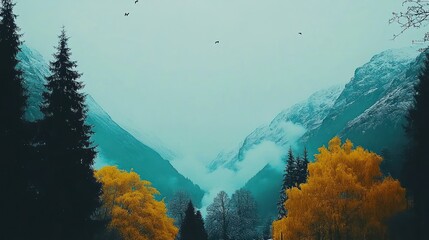 Wall Mural - misty mountain valley scene with snow-capped peaks and autumnal trees.
